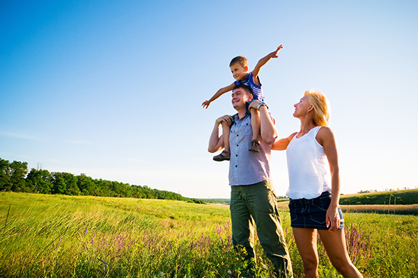 a happy family standing in a field